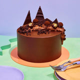 Ultimate Chocolate Cake with smooth dark chocolate ganache, handmade truffles, chocolate shards, and edible 24k gold decoration.